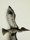 front close up of back of metal bird with hook attached