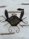 aerial back view of metal copper crab with hook attached to the back