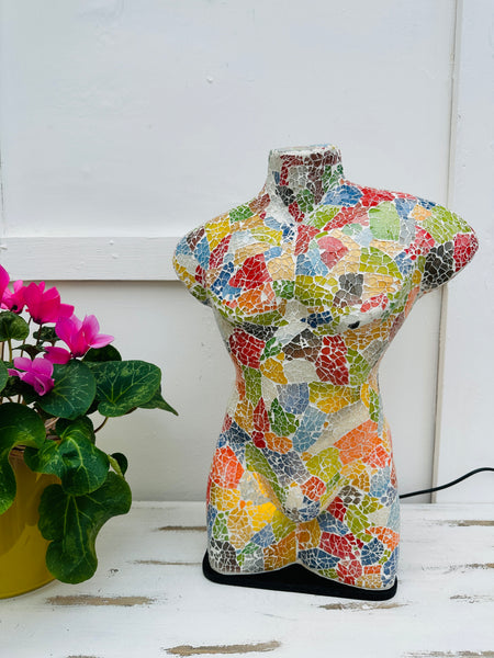 front view of mosaic man bust lamp with light on 