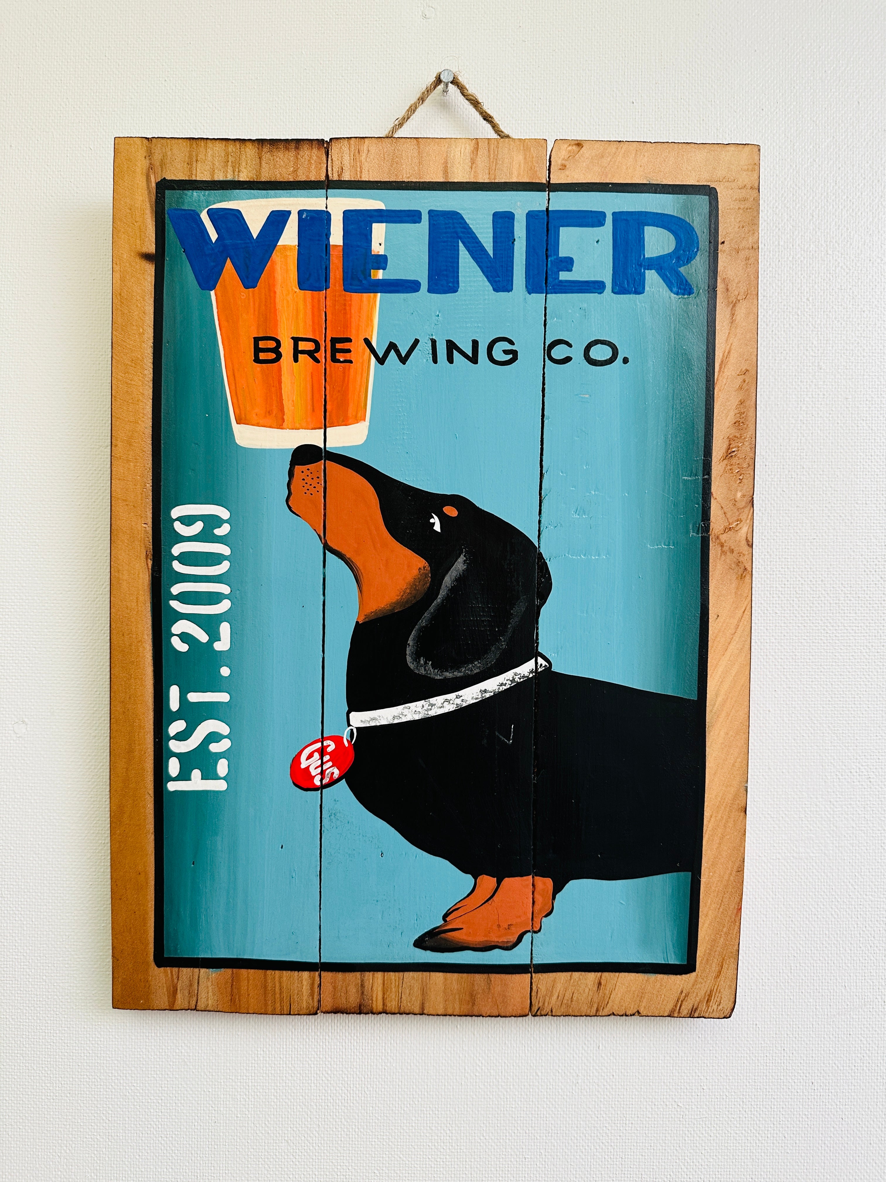 front view of wooden sign with wiener dog on