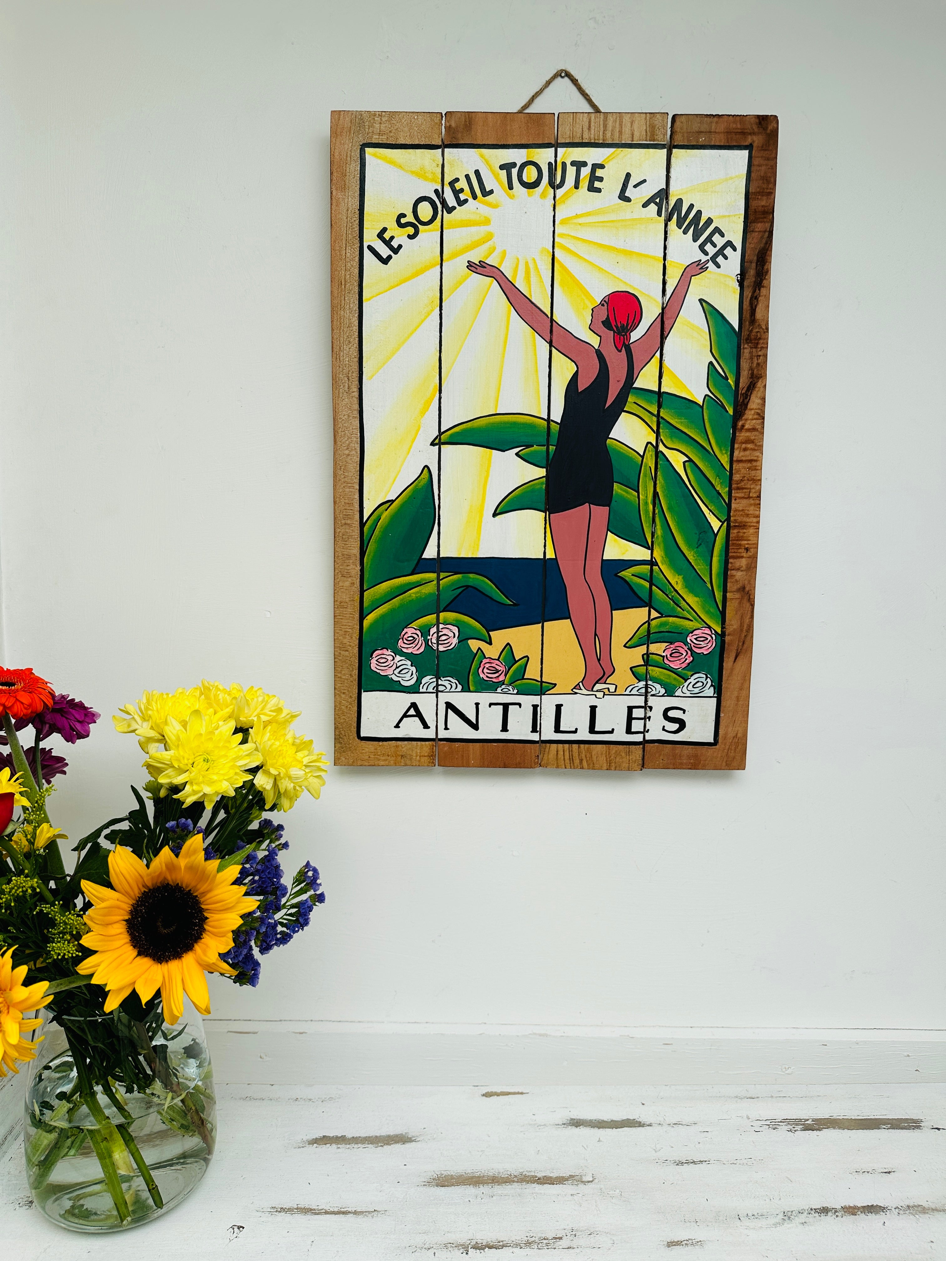 display view of antilles sign with a vase of flowers