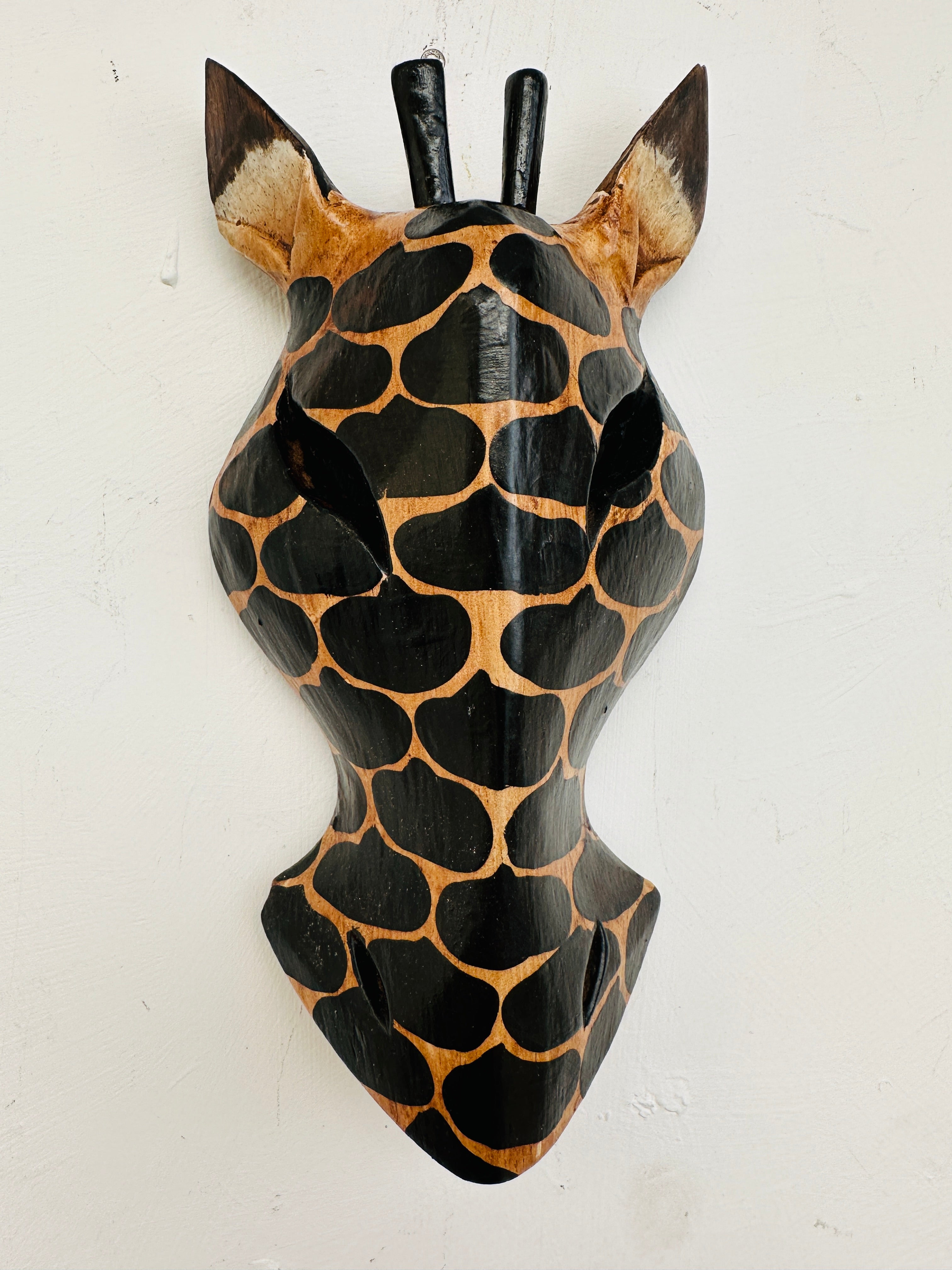 front view of wood giraffe mask