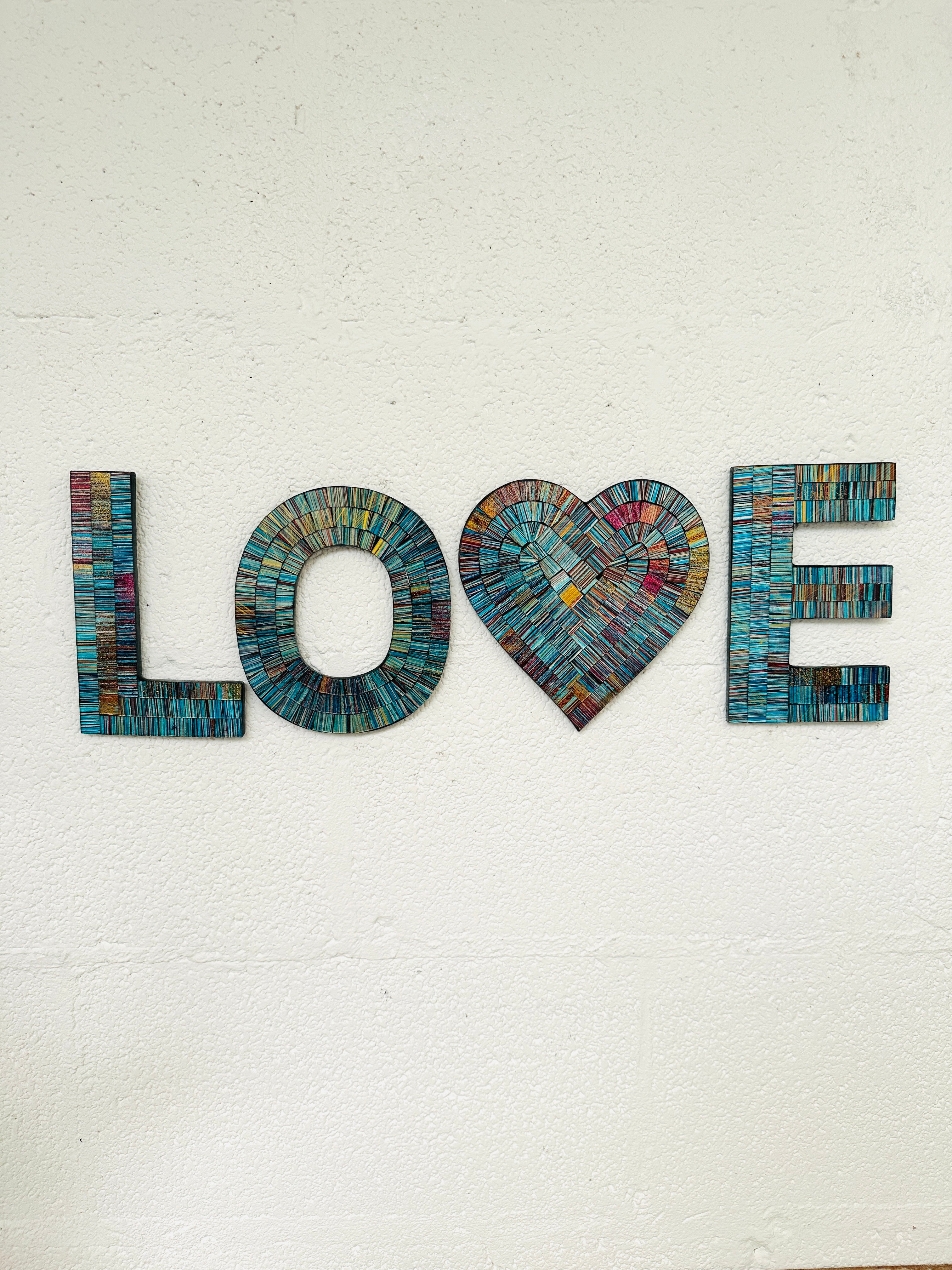 front view of mosaic love hung on the wall