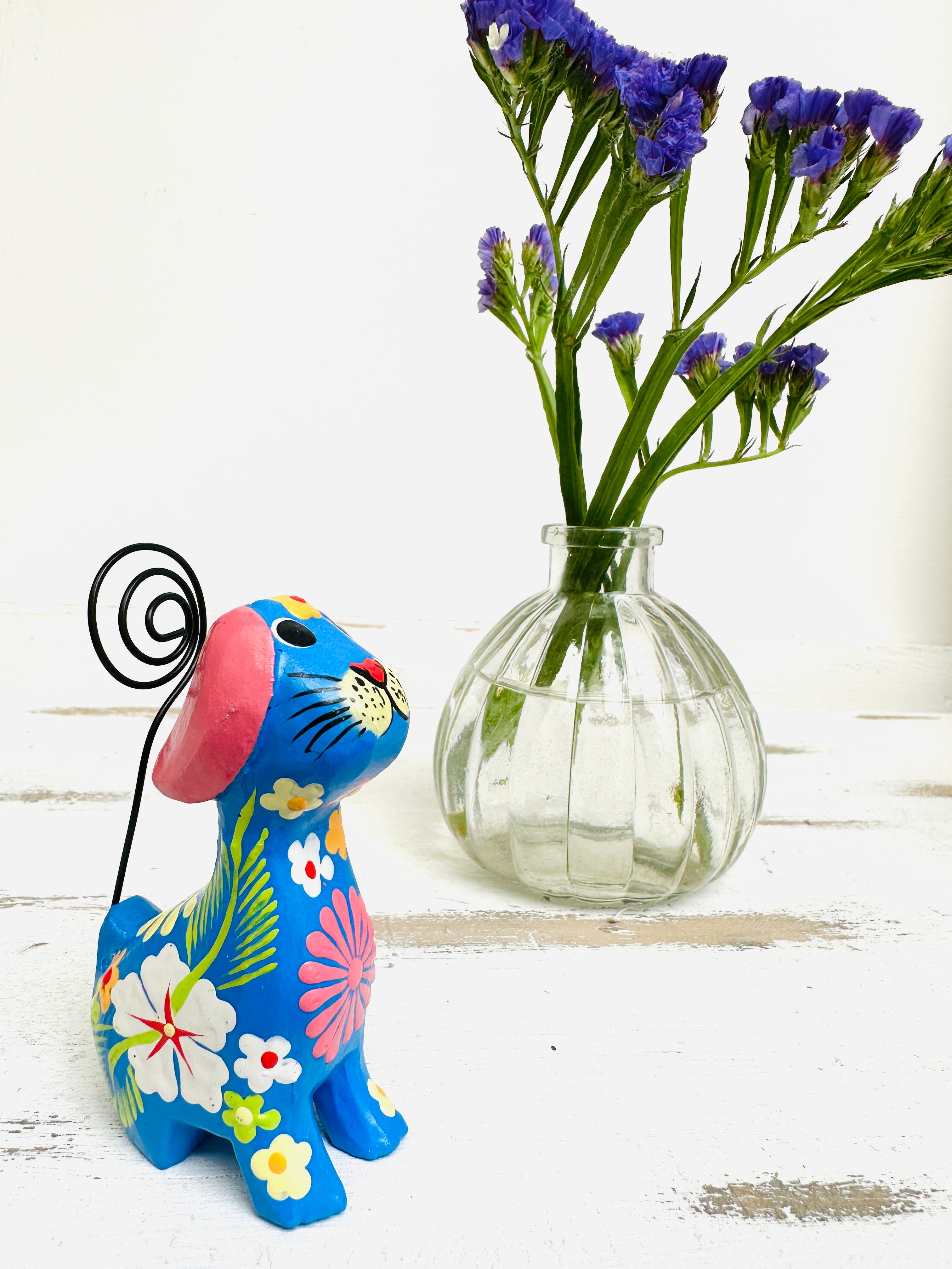 display view of blue flower dog next to a vase of flowers