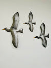 front view of set of metal flying birds