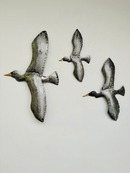 front view of set of metal flying birds