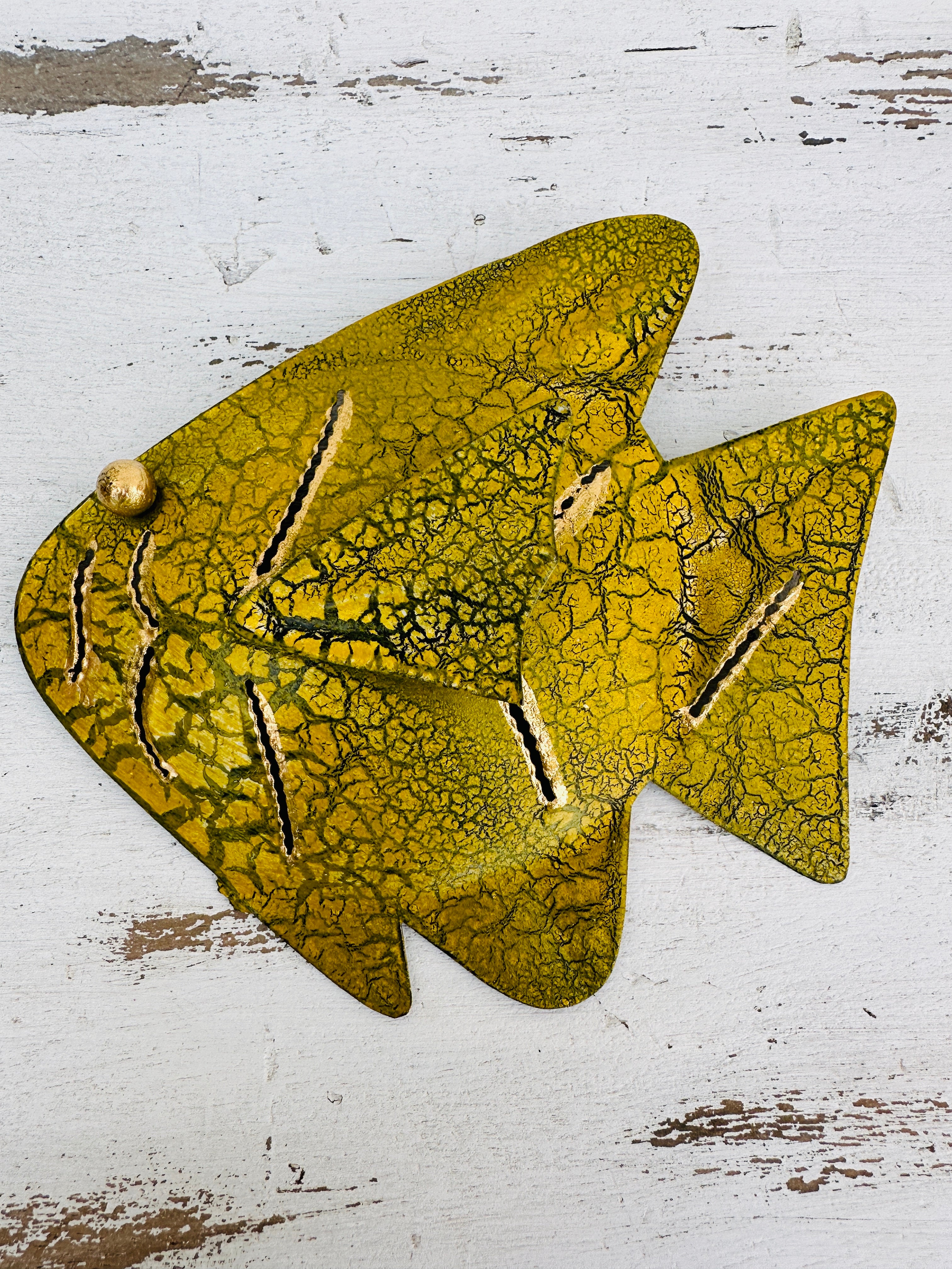 aerial view of single metal fish in yellow 