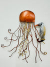 A copper-toned metal sculpture of a jellyfish with a small seahorse attached, both hand-painted with a unique finish.