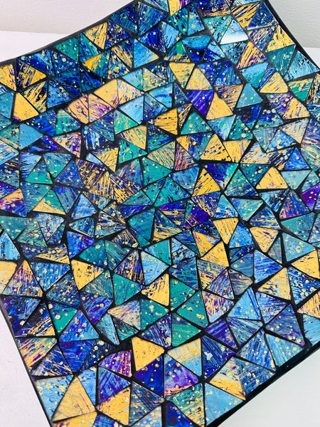 Top view of large handmade mosaic square plate showing detailed blue and cyan glass pattern in geometric layout.