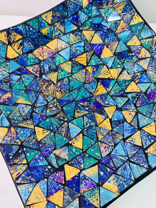 Top view of large handmade mosaic square plate showing detailed blue and cyan glass pattern in geometric layout.