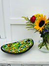 display view of mosaic oval bowl next to a flower vase.