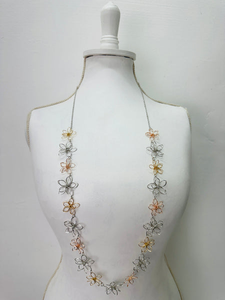 Necklace with floral designs on a mannequin 