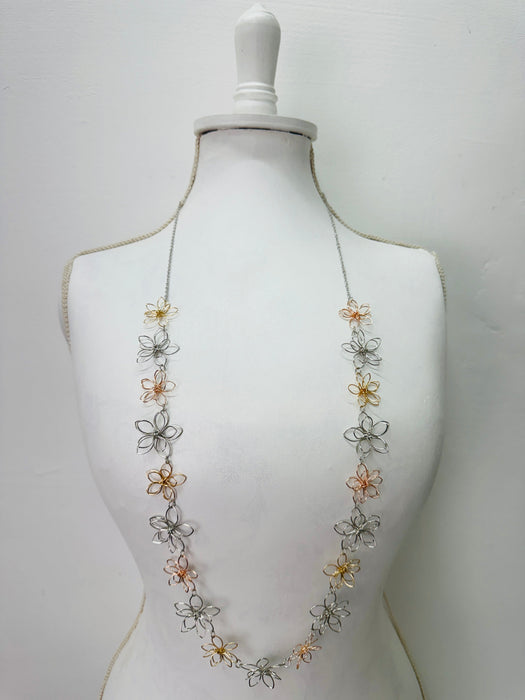 Necklace with floral designs on a mannequin 