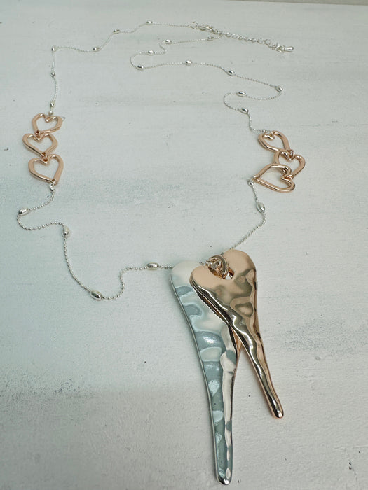 Necklace with heart-shaped pendants on a light gray background