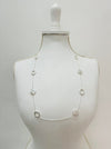 Long silver chain station necklace with acrylic faux-shell circles displayed on a mannequin