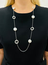 Long silver chain station necklace with acrylic faux-shell circles displayed on a model