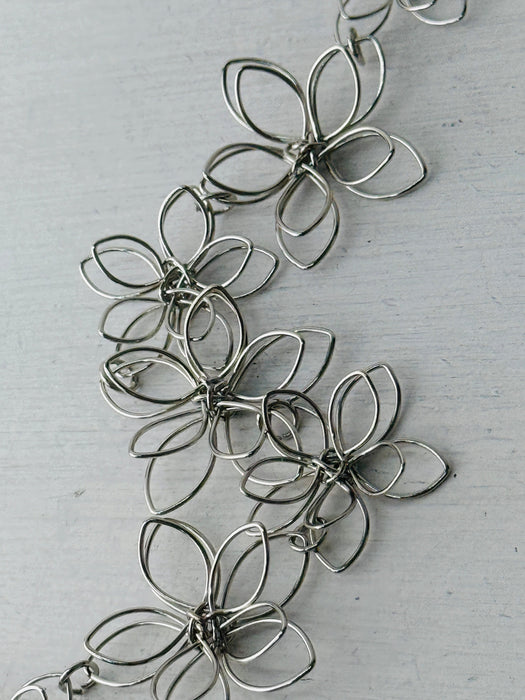 detail of silver floral necklace 