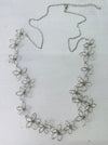 Silver floral necklace on a light white background