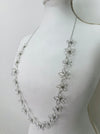 side angle of silver floral necklace on a mannequin 