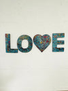 front view of mosaic love hung on the wall