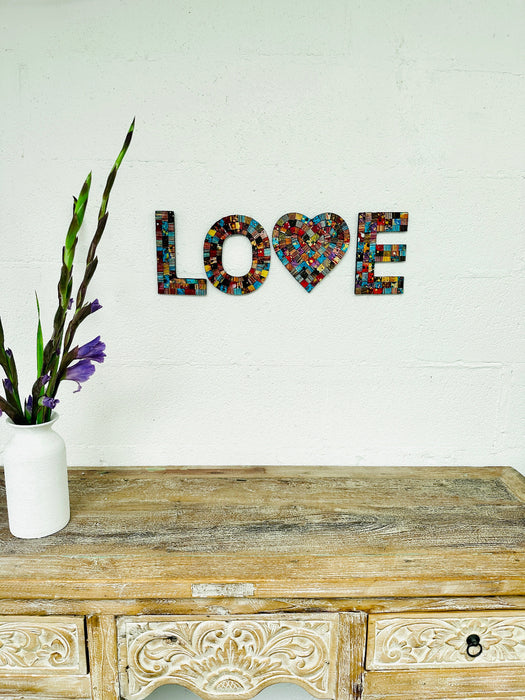 front view of mosaic love attached to a wall