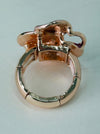Back view of adjustable enamel ring with elastic band in rose gold tone.