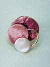 Three-layered enamel elastic ring with rose gold colours on a white background