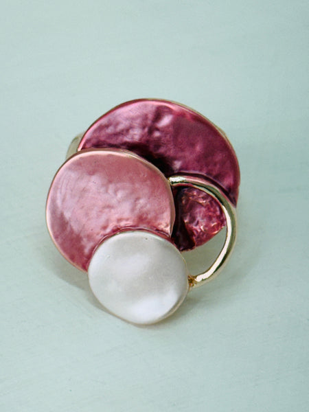 Three-layered enamel elastic ring with rose gold colours on a white background