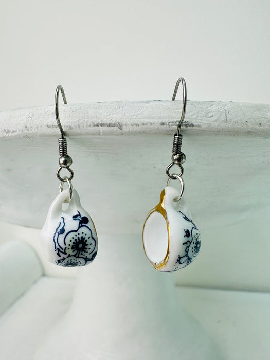 a pair of mini porcelain tea cup drop earrings with floral design