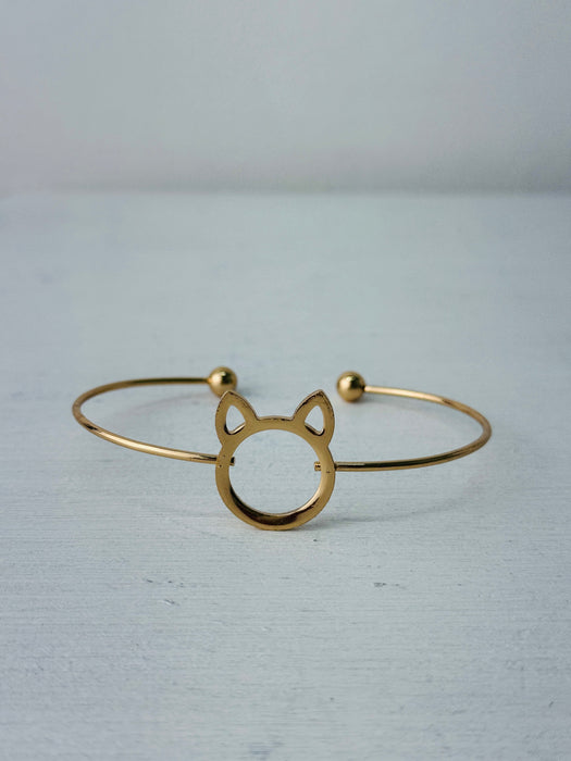 Minimalist gold-tone cat silhouette racelet with open bangle design