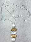Necklace with circular pendants on a light gray background