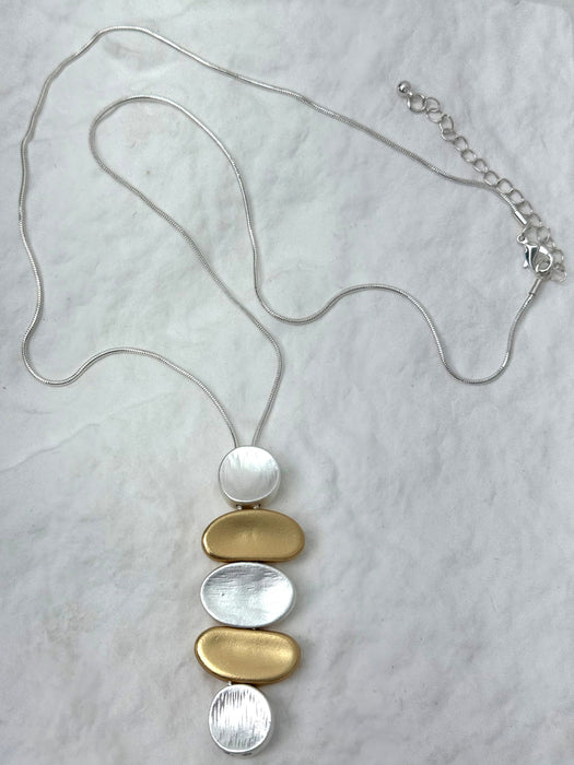 Necklace with circular pendants on a light gray background