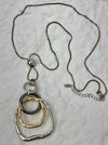 Necklace with three interlocking rings on a light gray background
