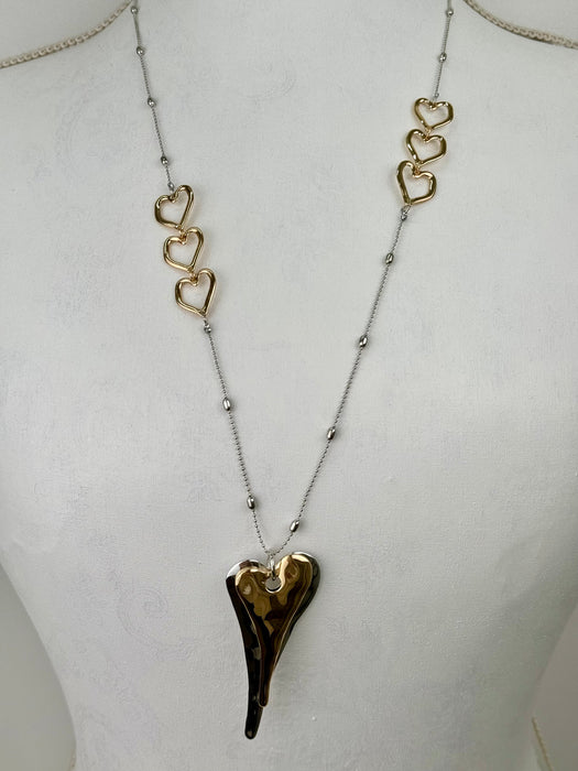 Necklace with a heart-shaped pendant on a mannequin bust.