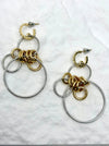 Pair of gold and silver hoop earrings on a white background