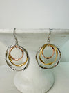 Pair of gold and silver hoop earrings on a white surface
