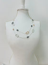 Necklace with multicolored gemstones on a mannequin bust against a white background