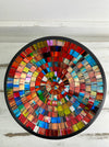 Top view of handmade mosaic glass bowl in Fragaria tones showing circular red, pink, blue and gold glass pattern.