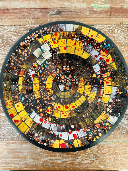 Top view of handmade mosaic glass bowl in Siena tones showing circular pattern of amber, gold, and copper mosaic pieces.