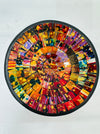 Top view of handmade mosaic Calypso bowl showing bright red, orange, yellow and gold glass pieces arranged in circular pattern.