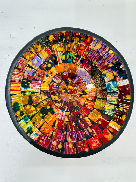Top view of handmade mosaic Calypso bowl showing bright red, orange, yellow and gold glass pieces arranged in circular pattern.
