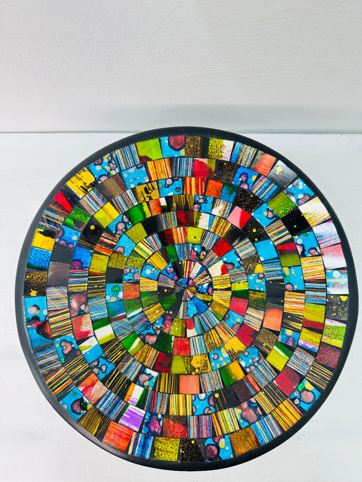 Top view of handmade mosaic glass bowl in Sterope tones showing colourful circular glass pattern on white background.