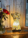 Handmade mosaic bust lamp glowing warmly in black and gold tones.