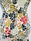 Close-up of hand-painted multi-colour mosaic glass pattern.