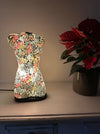 Mosaic bust lamp glowing warmly, showing colourful glass pieces.
