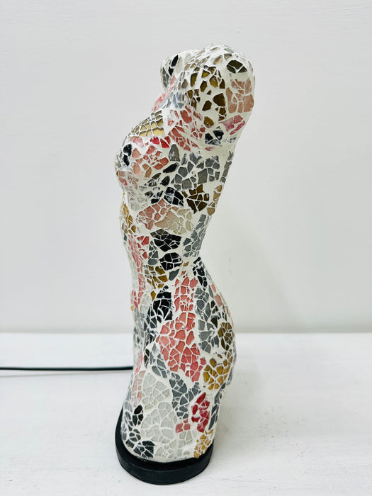 Side view of colourful mosaic bust lamp with geometric glass pattern.