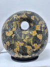 Handmade mosaic donut lamp in black and gold, shown turned off to display the intricate glass pattern and texture.