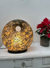 Handmade mosaic donut table lamp in black and gold with warm white LED light, decorative lighting by The Red Gecko