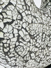 Detailed close-up of silver crackle mosaic glass texture