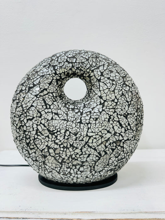 Close-up of silver mosaic glass surface with hand-painted pattern